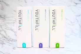 Three Youth Fill products by Nutrination on a marble surface, showcasing medium-density hyaluronic acid fillers.