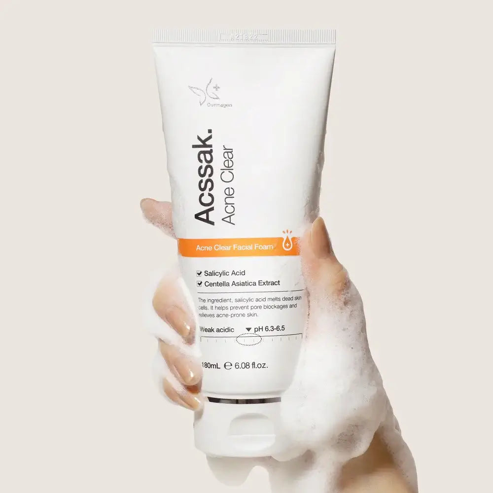 Acssak Foam Cleansing 180ml tube being held with foamy cleanser; deep pore cleansing for all skin types.
